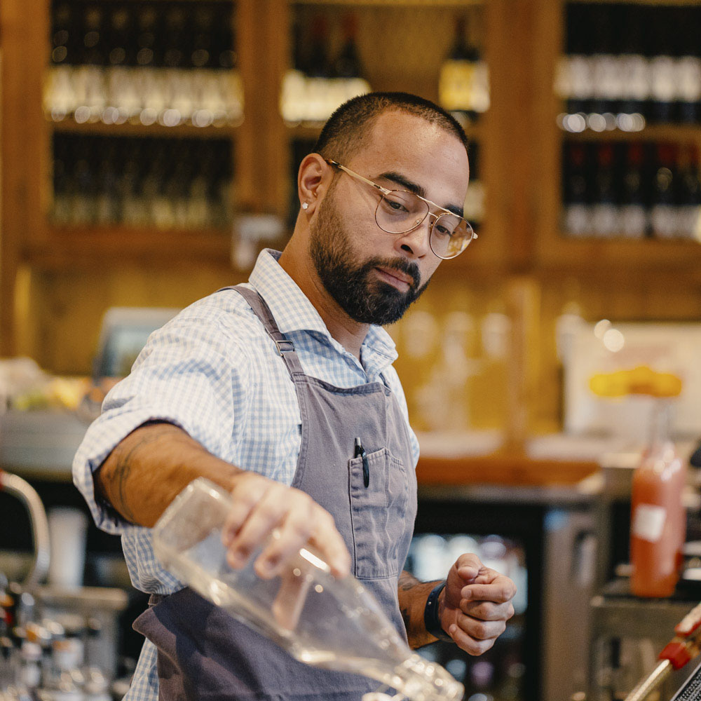 Photo of a bartender pouring water