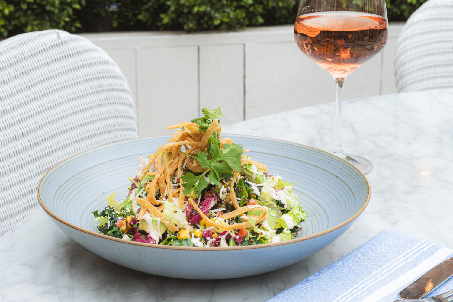 Summer House's Costa Mesa salad available on the Las Vegas Restaurant Week menu next to a glass of rosé.