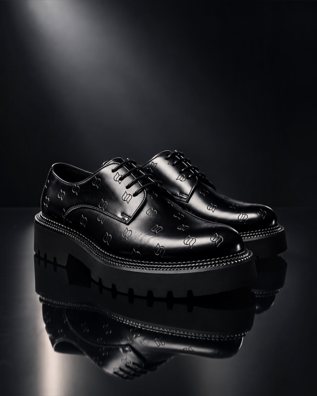 Close detail of a hand-finished black leather shoe