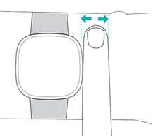 A watch on someone's wrist, with one finger between the watch and their wrist to show placement
