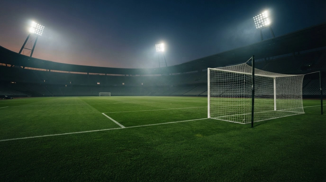 An empty professional football stadium pitch at night, representing the absence of an official Bafana Bafana squad announcement by Pitso Mosimane.