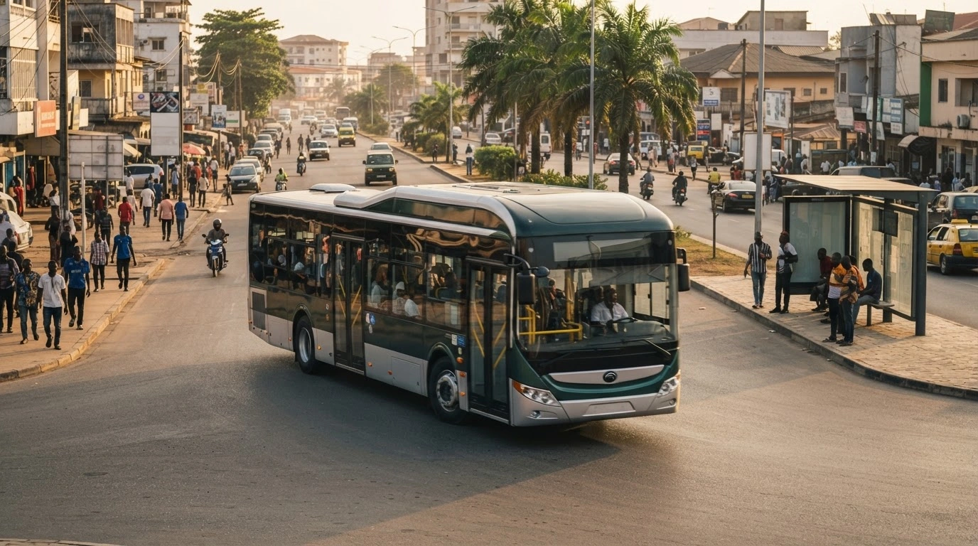 A modern public transport bus operates on a city street in Gabon as part of the new National Transport Company fare system.