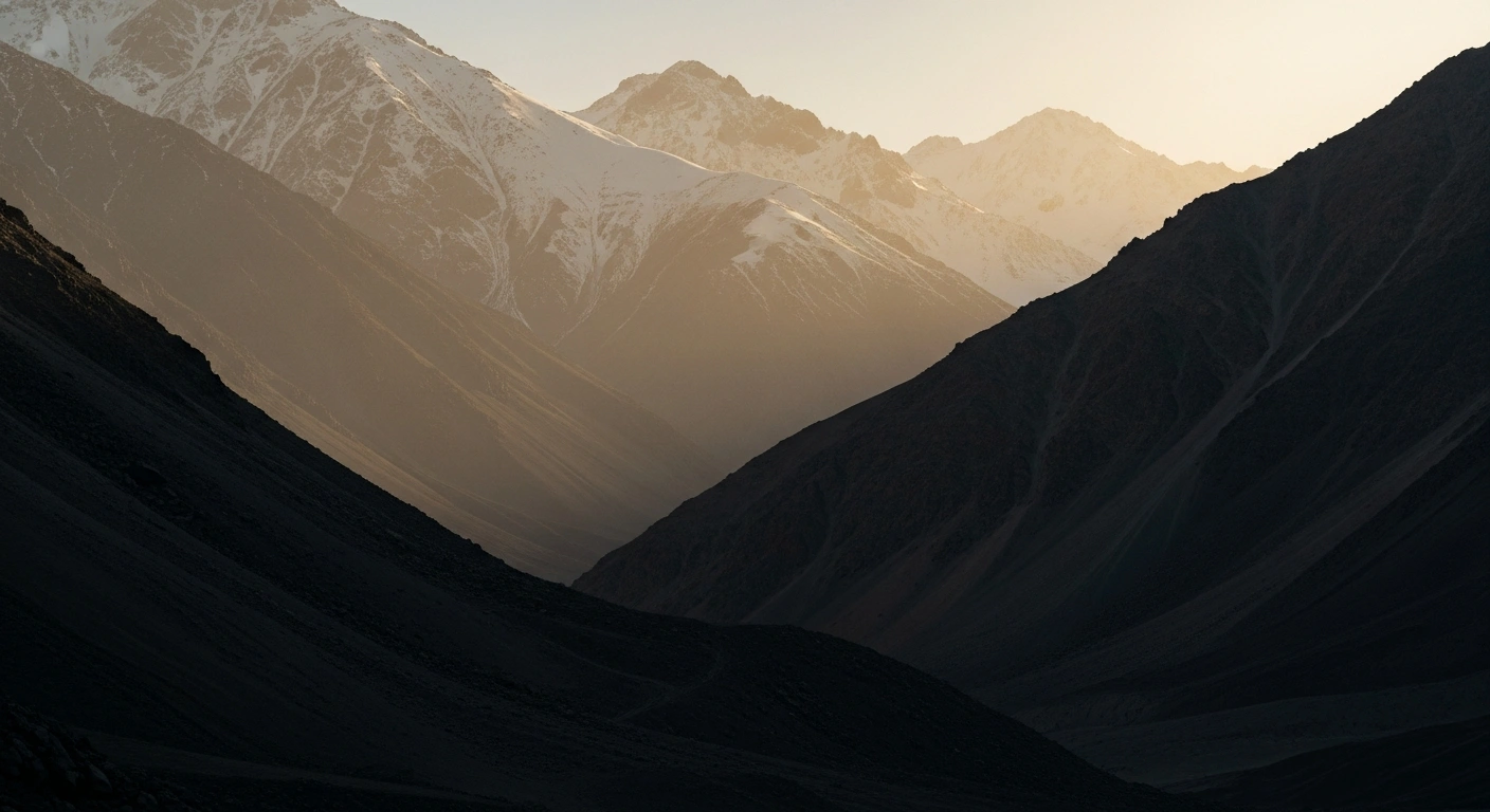 The rugged mountain landscape near the Kyrgyzstan and Tajikistan border is shown under a hazy sky following reported seismic activity.