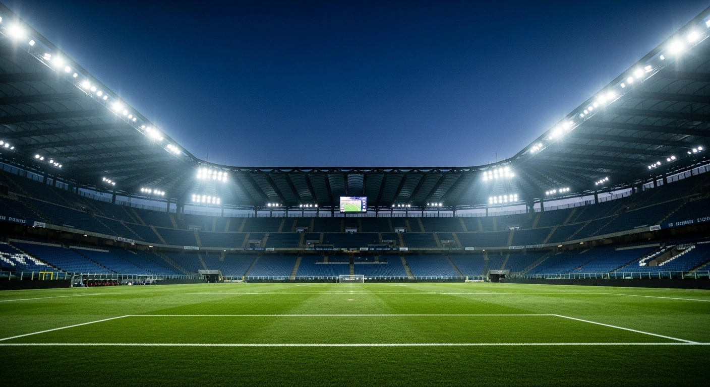 A wide, low-angle shot of a grand, floodlit Italian football stadium at twilight, with an emerald green pitch and empty stands, symbolizing the anticipation for the Serie A 2025/2026 season's 17th matchday fixtures, including Atalanta vs. Inter Milan and Pisa vs. Juventus, scheduled for December 27-29, 2025.