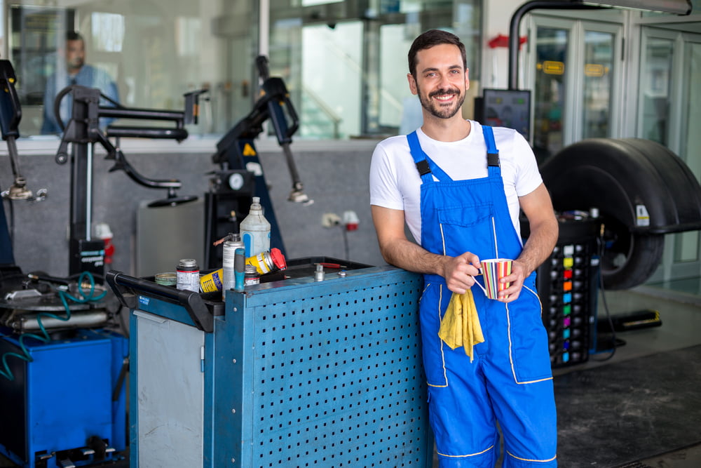 mechanic showing how to use a tire machine