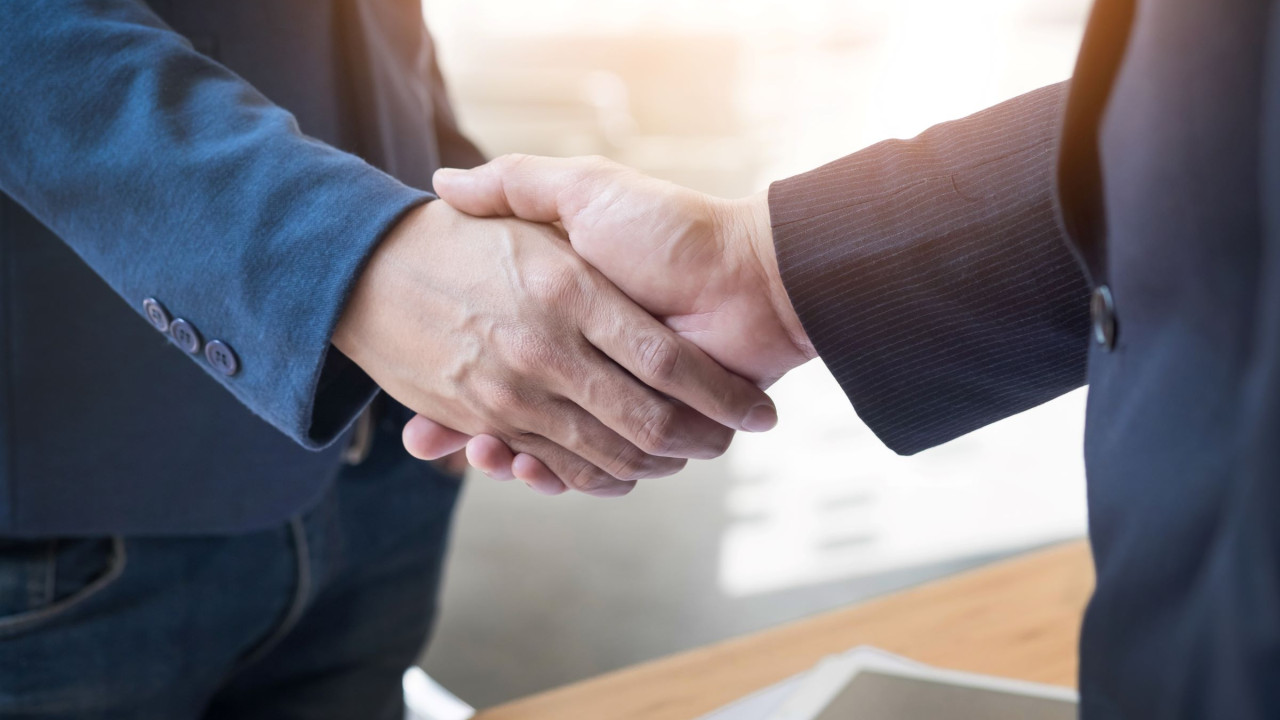 64070587c8532__two-confident-business-man-shaking-hands-during-a-meeting-in-the-office-success-dealing-greeting-and-partner-concept.jpg