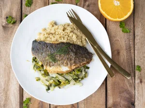 Fried sea bass with stewed vegetables and quinoa