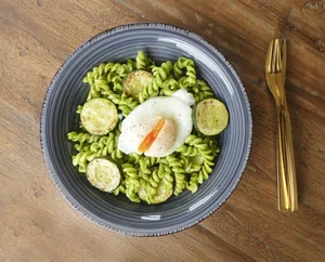 Spinach pesto pasta with poached egg