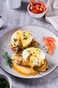 Eggs benedict on toasted waffles