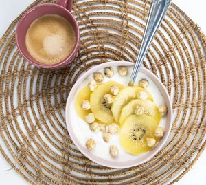 Breakfast bowl with gold kiwi and hazelnuts