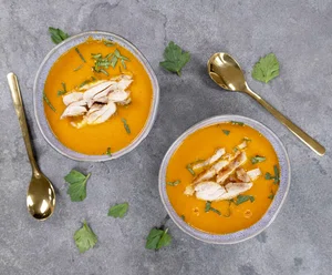 Carrot soup with pan-fried chicken strips