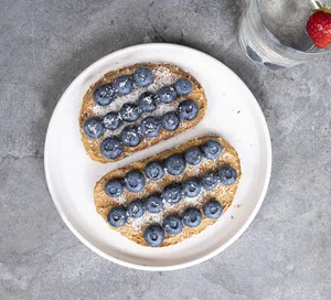 Toast with nut butter, berries and coconut