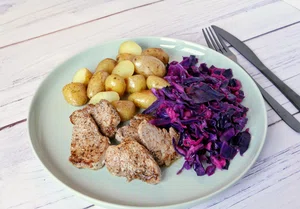 Fried pork tenderloin with red cabbage and apple