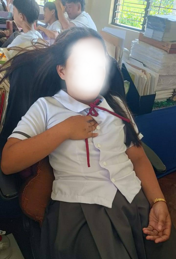 The image of a school girl fainting due to over-heat in the classroom