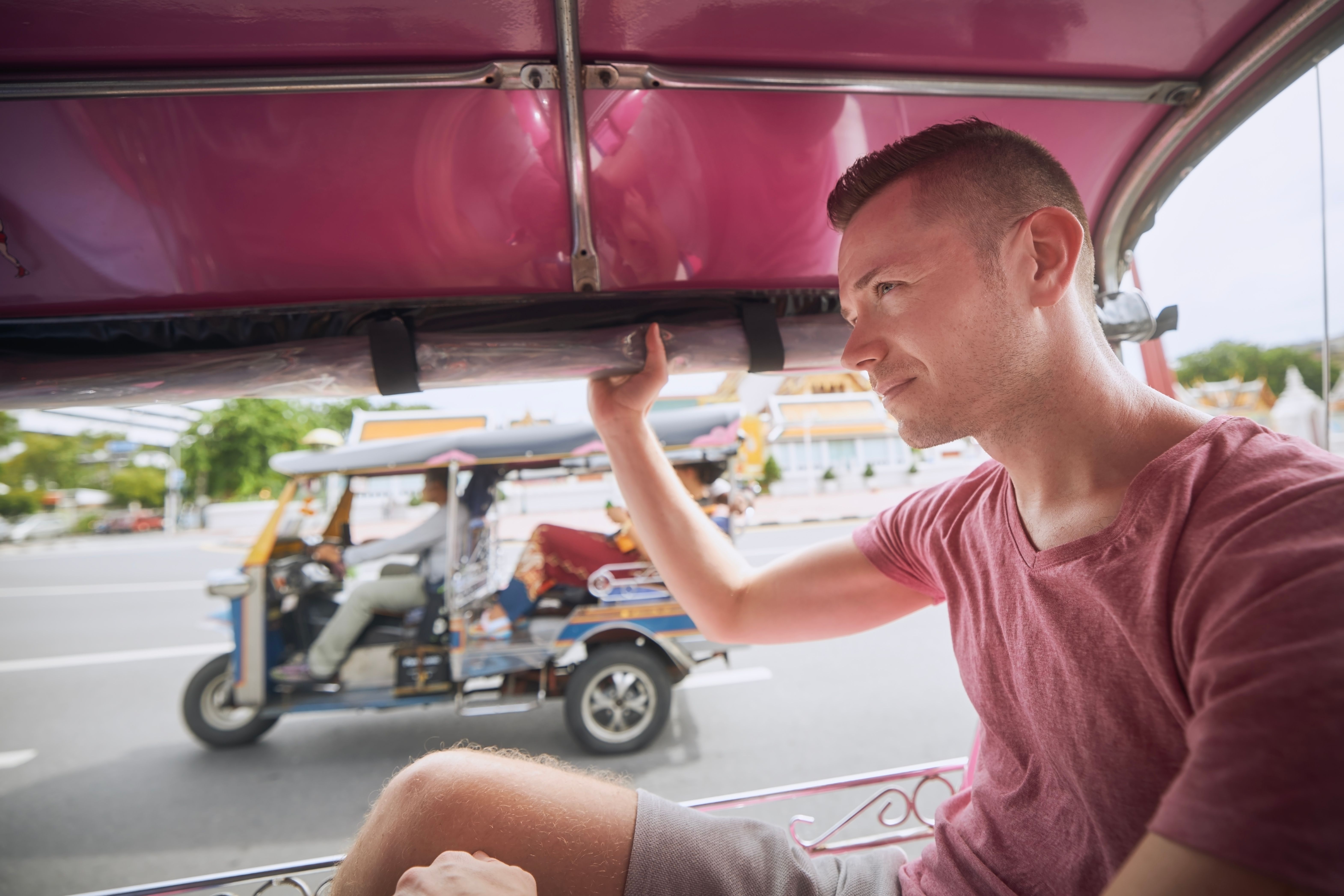 foreigner enjoy riding the tuk tuk ride
