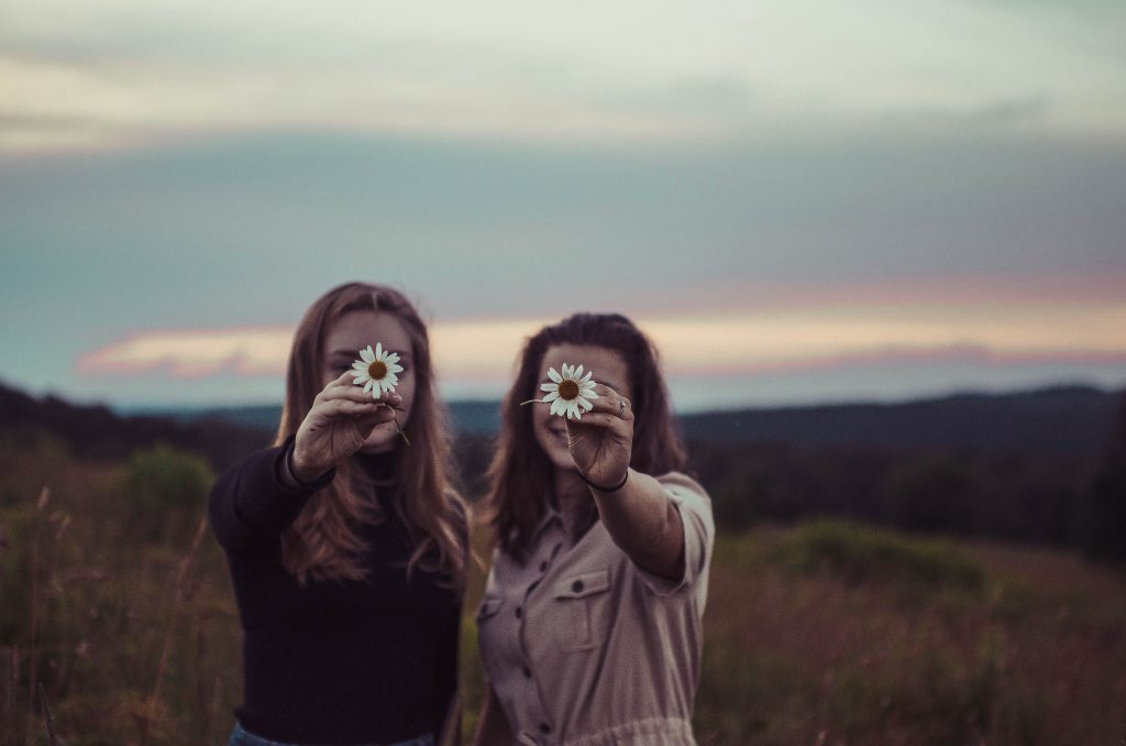 Two Girls Showing Flower