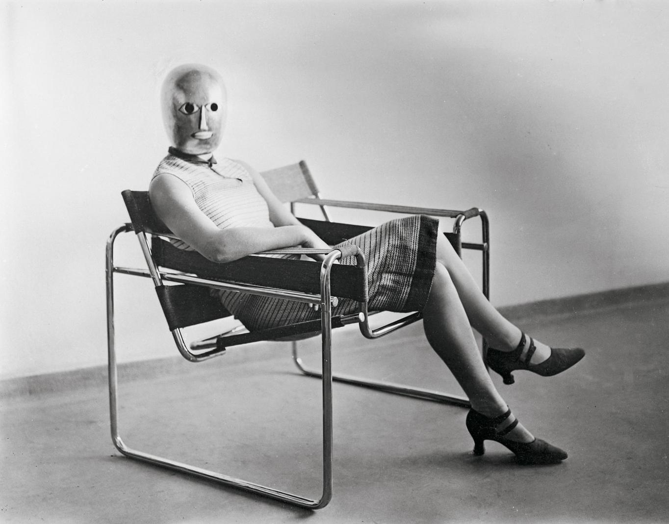 Erich Consemüller, Woman in B3 club chair by Marcel Breuer wearing a mask by Oskar Schlemmer, ca. 1926