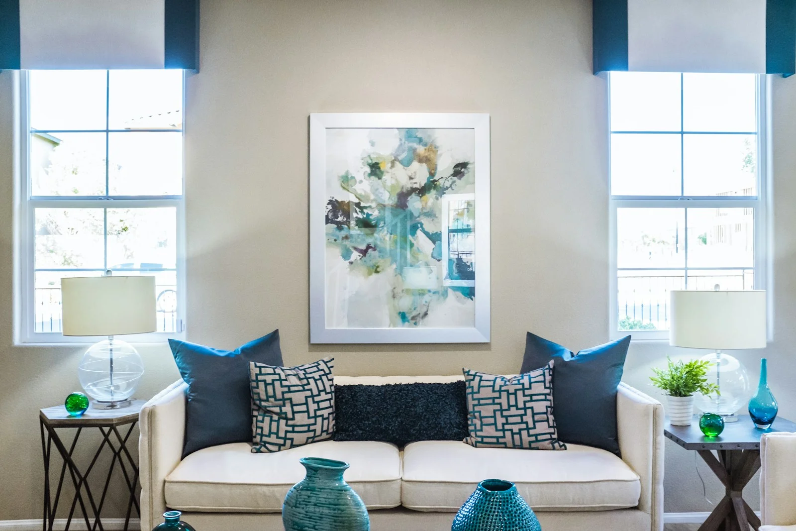 Large canvas above a soft sofa in a sunlit living room