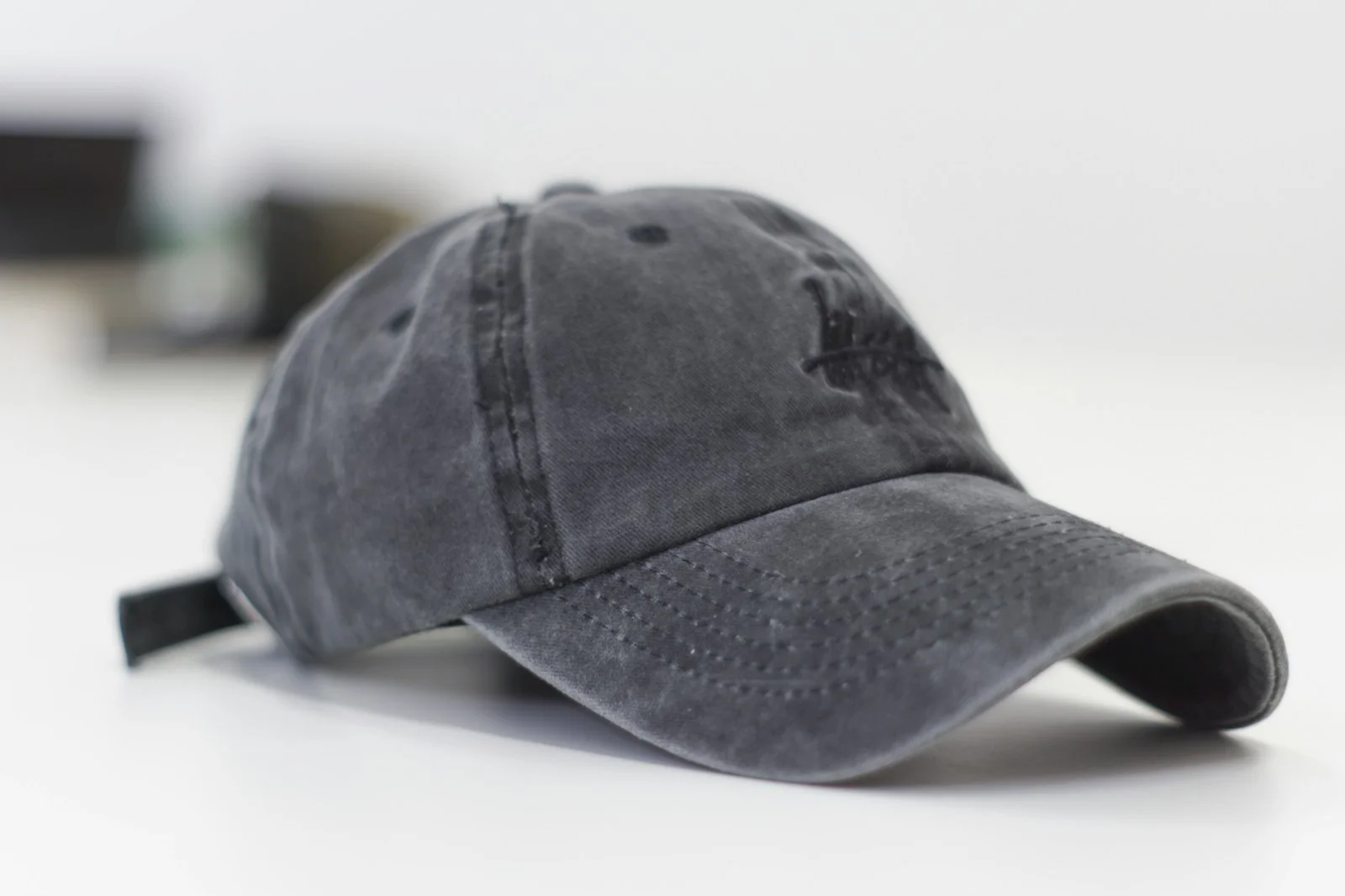 Cream baseball cap on a wooden table with overhead light