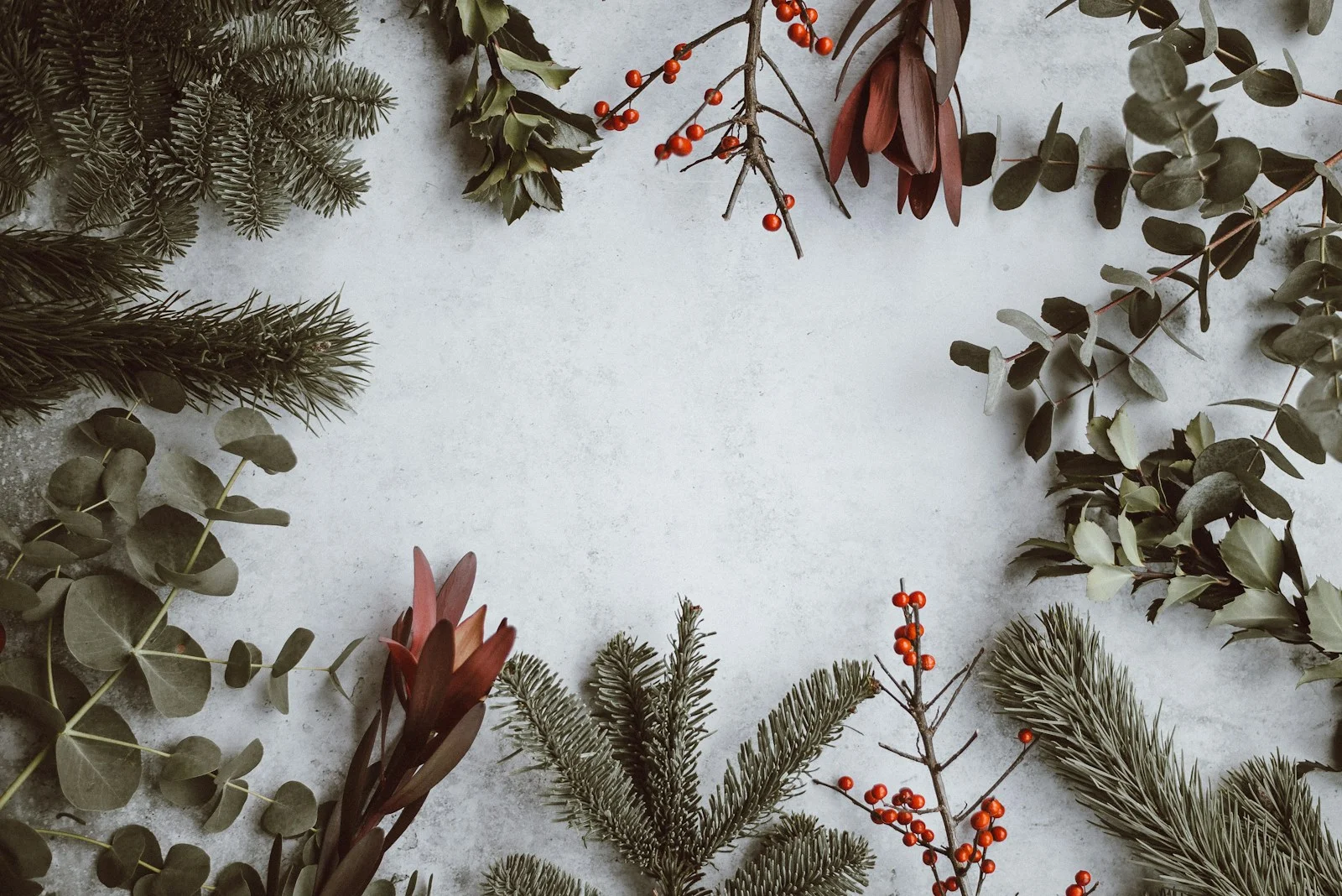 Wrapped Christmas gifts beside a soft-lit pine tree in warm holiday tones