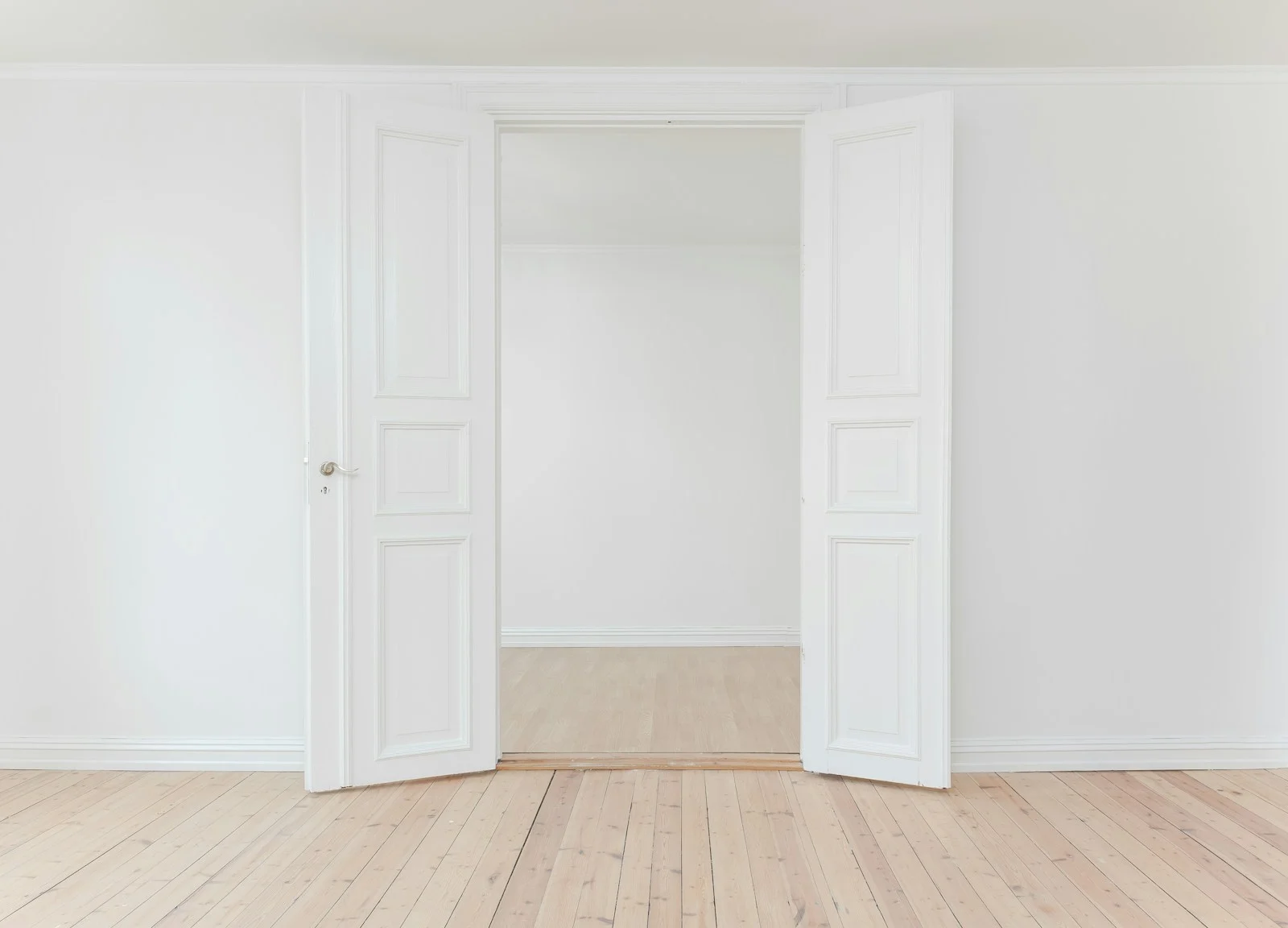 Gallery wall with multiple framed AI posters in a cream-toned room