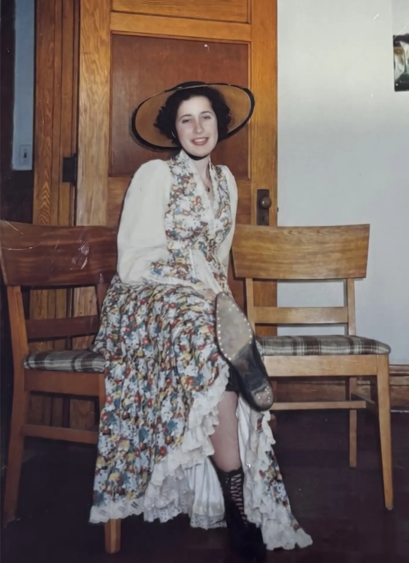 Tashi in a bonnet and floral dress for a creative performance