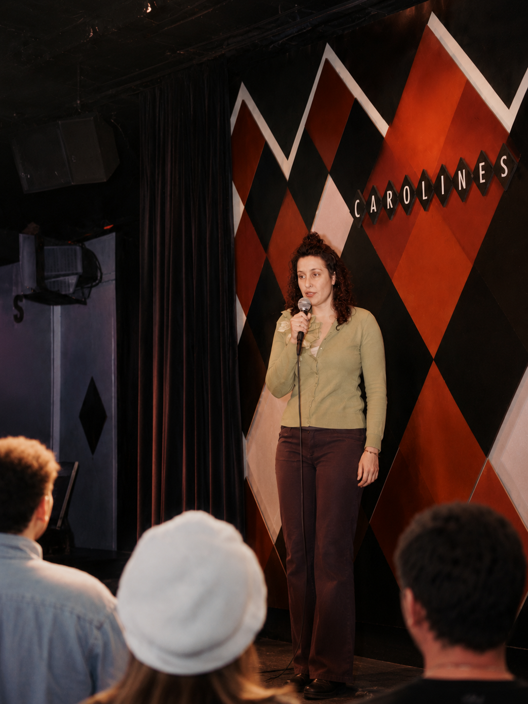 Tashi performing stand-up comedy on stage