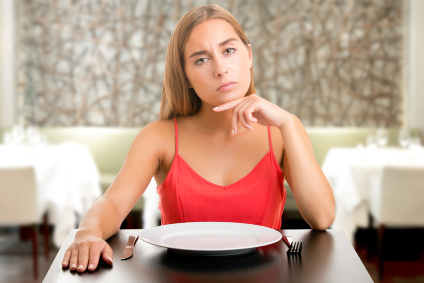 An image of hungry woman on a diet to illustrate different types of fasting