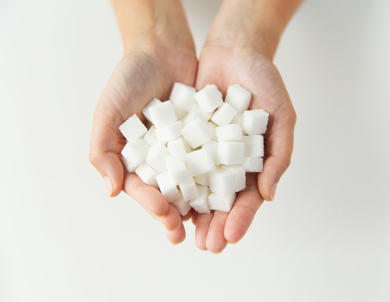 An image of a handful of sugar cubes to illustrate alternatives to sugar.