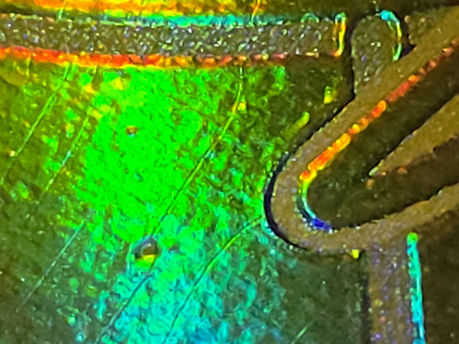 The deeper of the two marks. The holo is still present inside it.