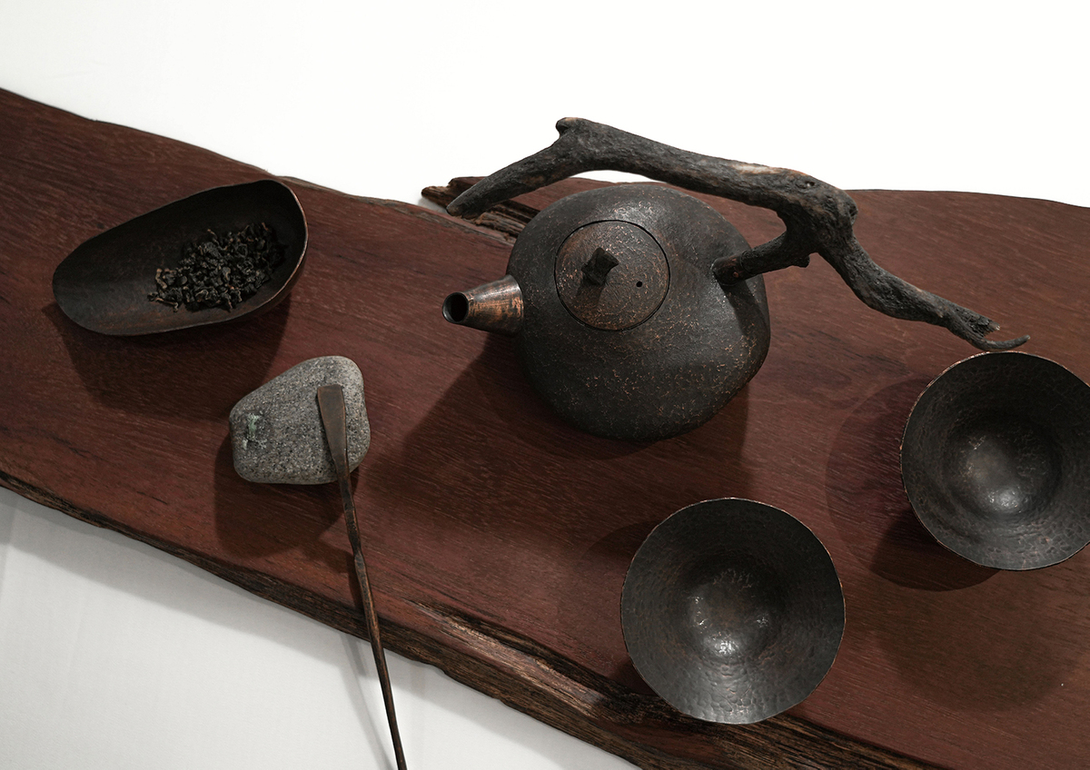 The first teapot features smooth surfaces and patterns reminiscent of pebbles, while the teaspoons, tea leaves, and teacups each have their own unique stone-like textures.