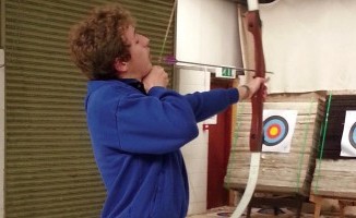 Cameron McKendrick enjoys archery with support from a personal assistant