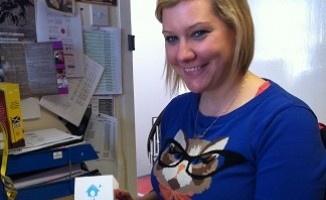 Katriona with her favourite item from her desk - a cupcake box