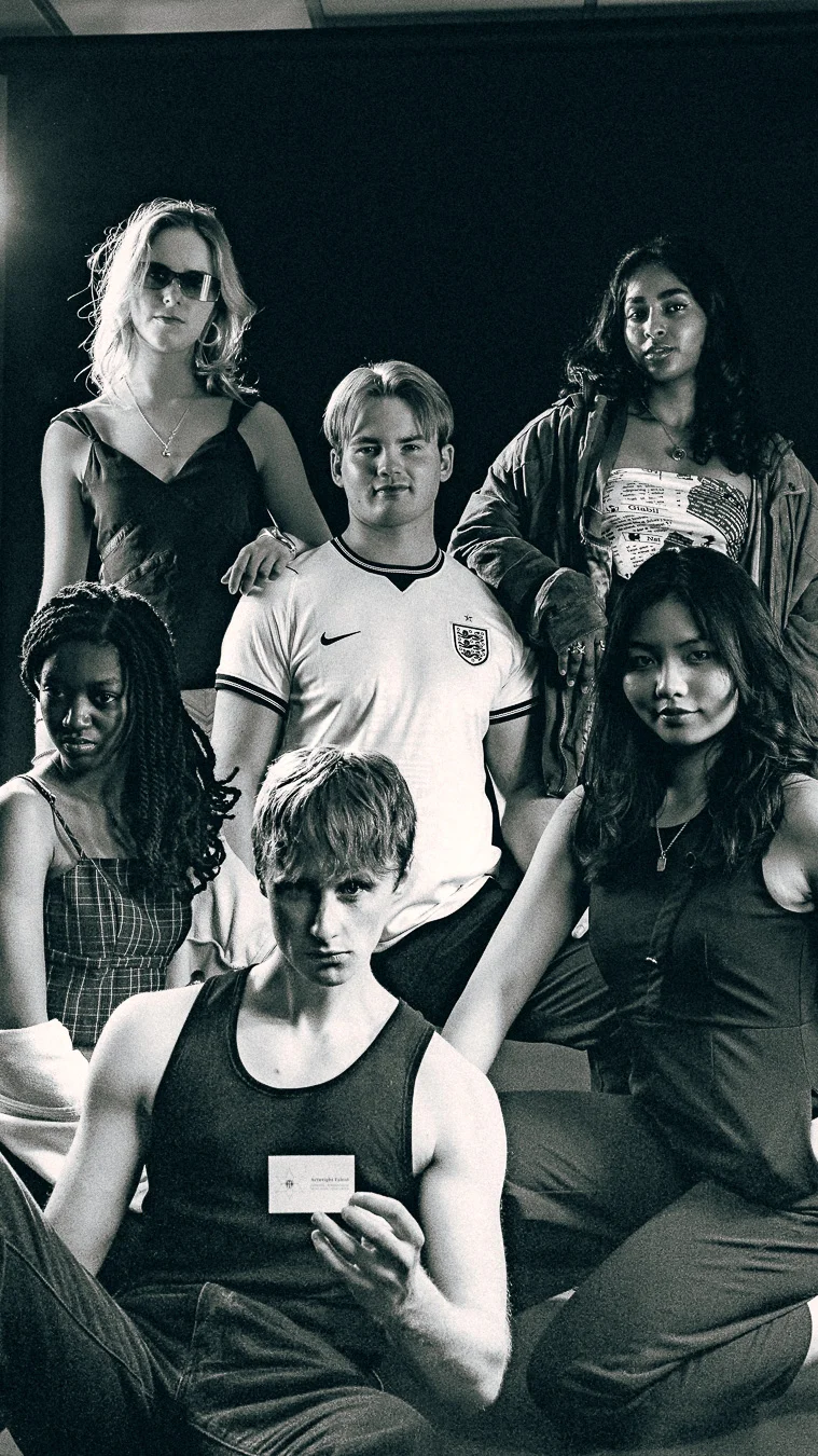 Black and white studio portrait of five diverse young adults posing with serious expressions.