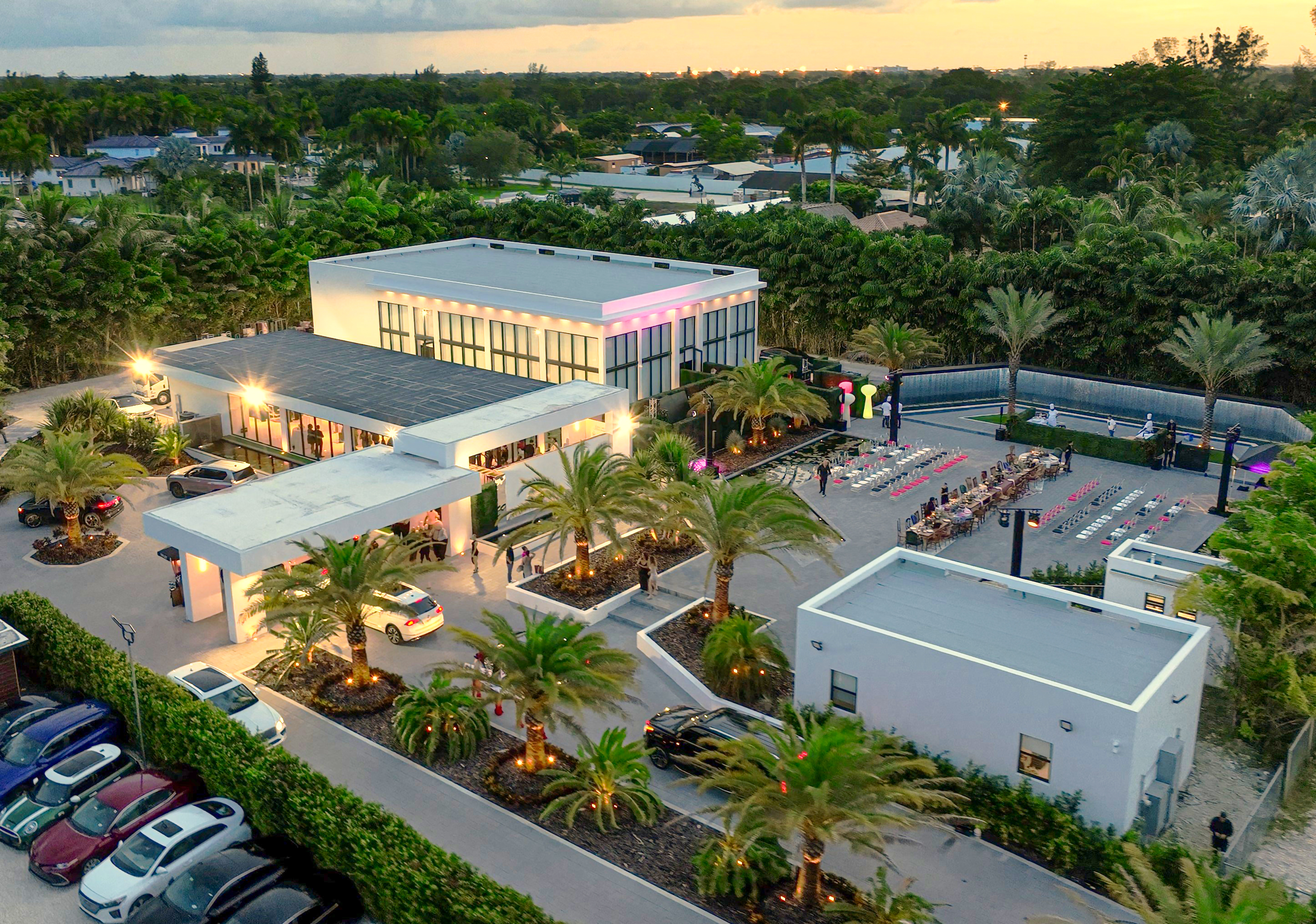 The Glass Venue exterior with floor-to-ceiling glass walls and 90-foot waterfall backdrop