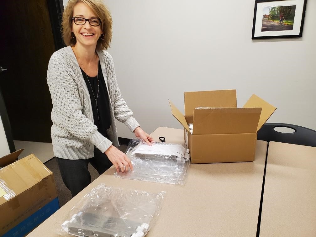 Team member unpacking boxes