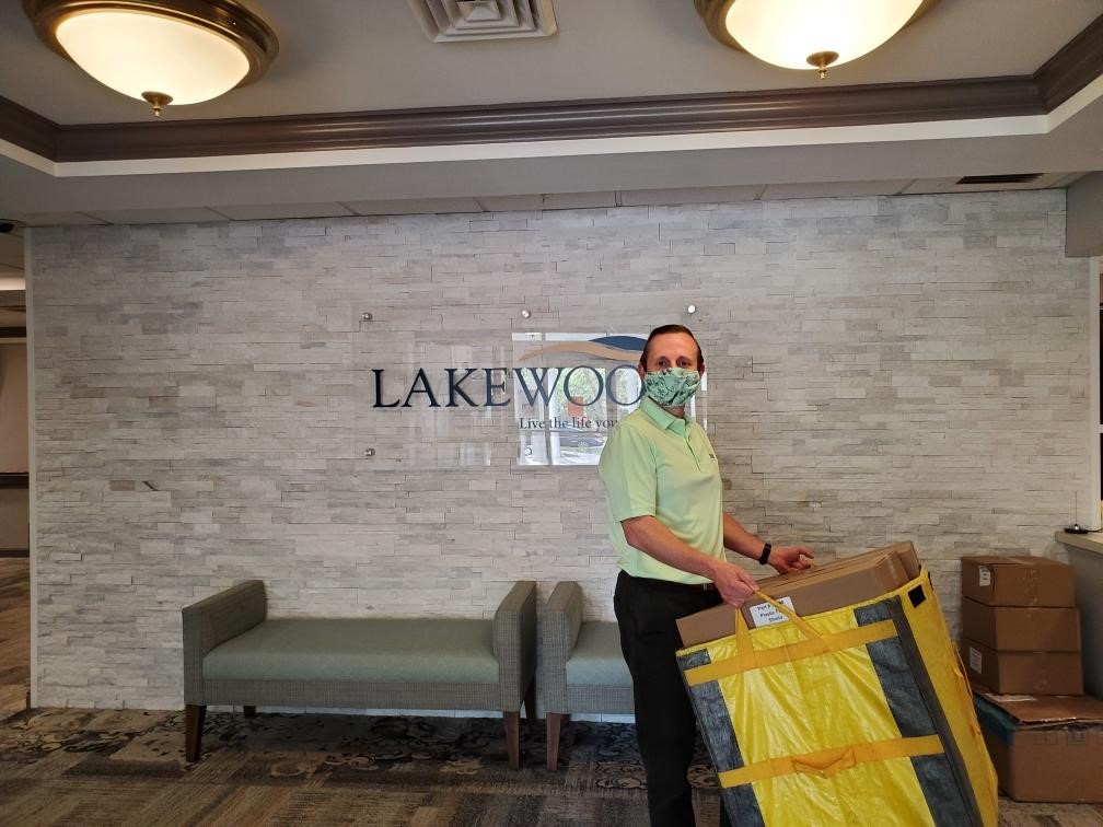 Team member carrying boxes into senior living community