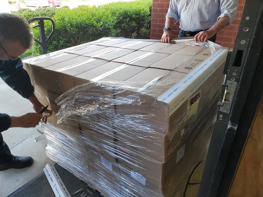 teamworkers unpacking crate of boxes