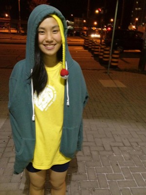 Standing outside the YMCA in Daniel's hoodie and pikachu hat, waiting for a pickup ride.