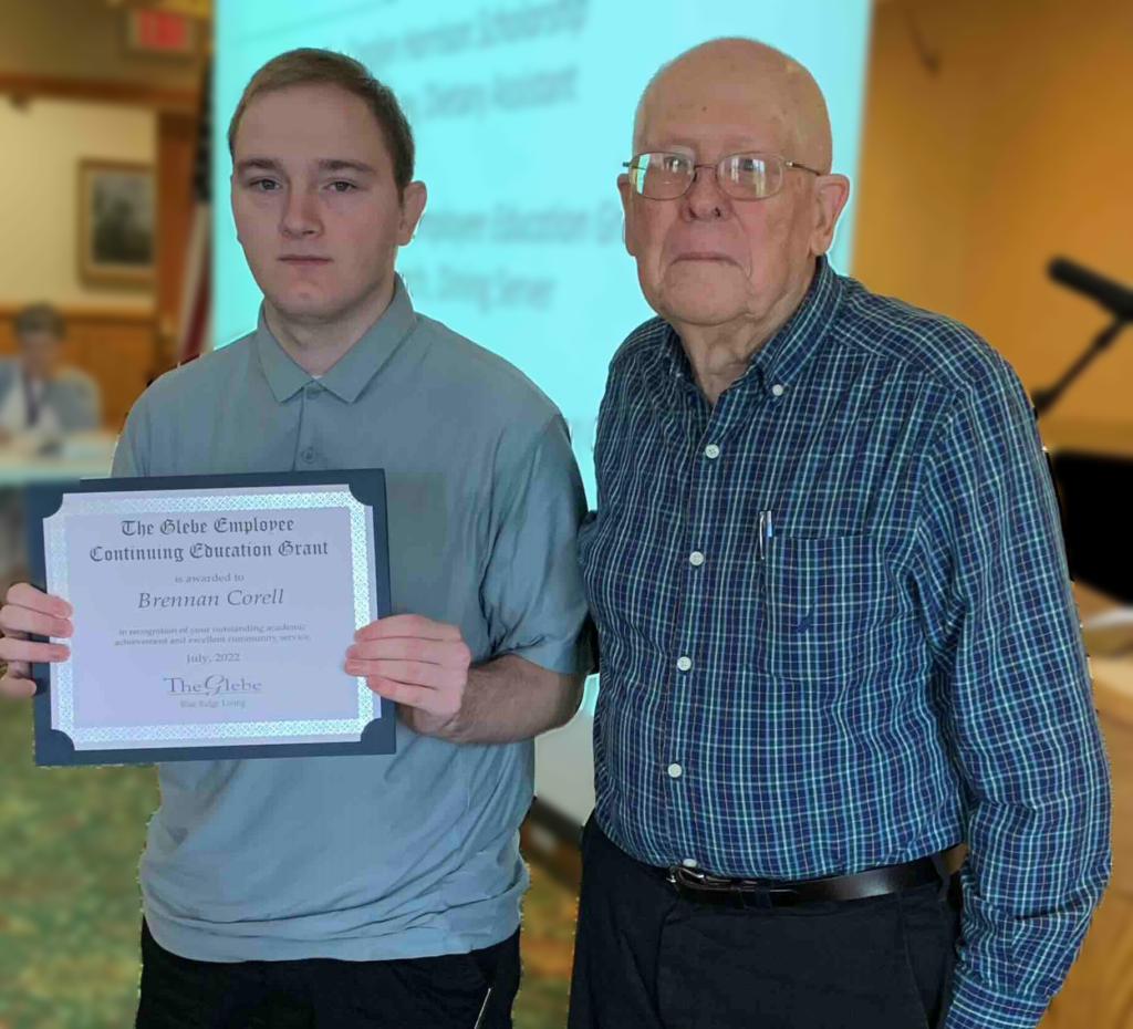 Scholarship Recipient Corell accepting his scholarship from The Glebe