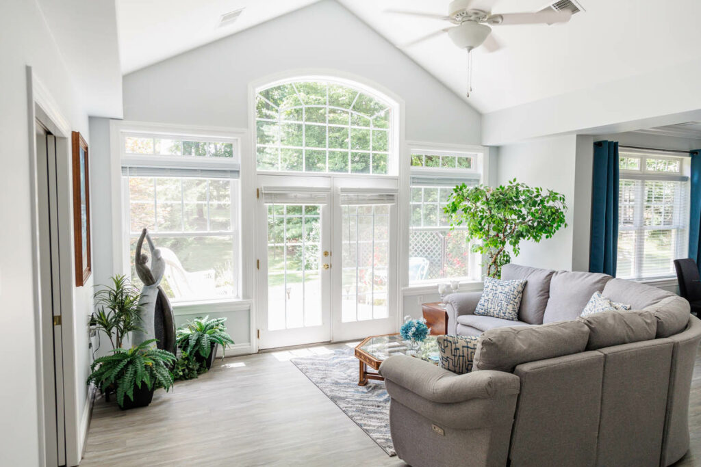 living room with large windows and doors to an exterior porch