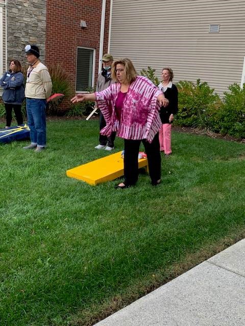 Woman tossing bean bag at the cornhole event