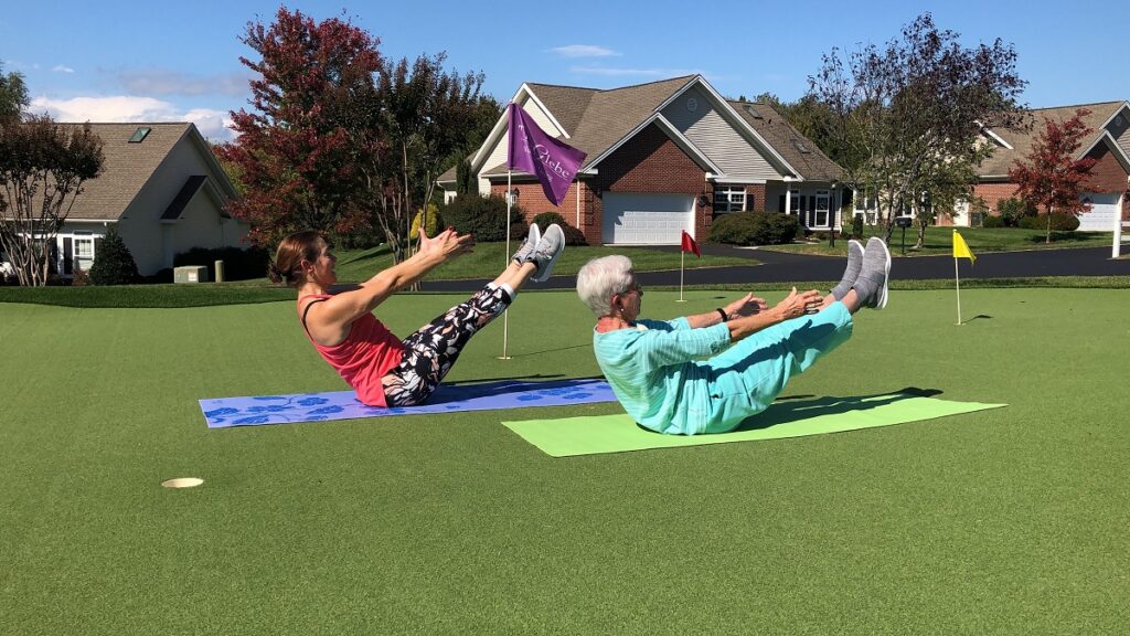 Senior residents doing Pilates outdoors.