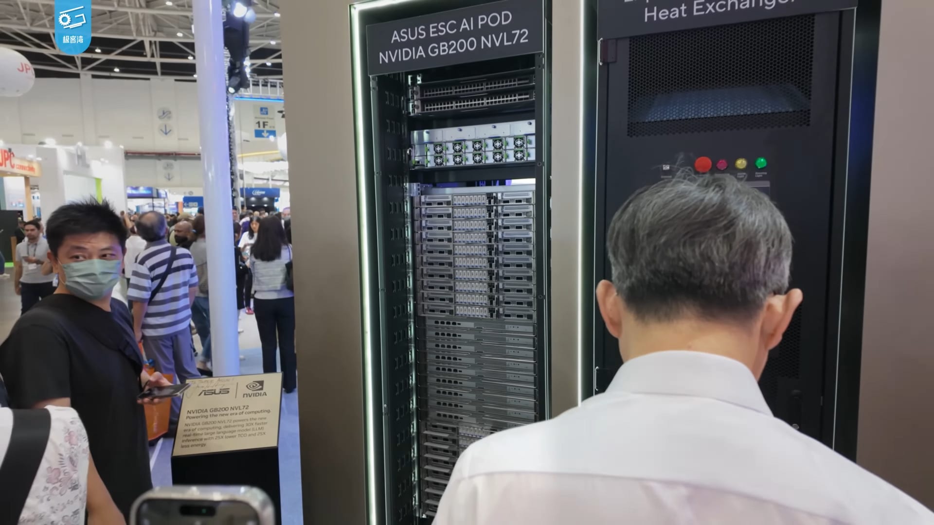 An ASUS ESC AI POD rack built on Nvidia GB200 NVL72 GPU systems on display at COMPUTEX 2024, with attendees walking the show floor.