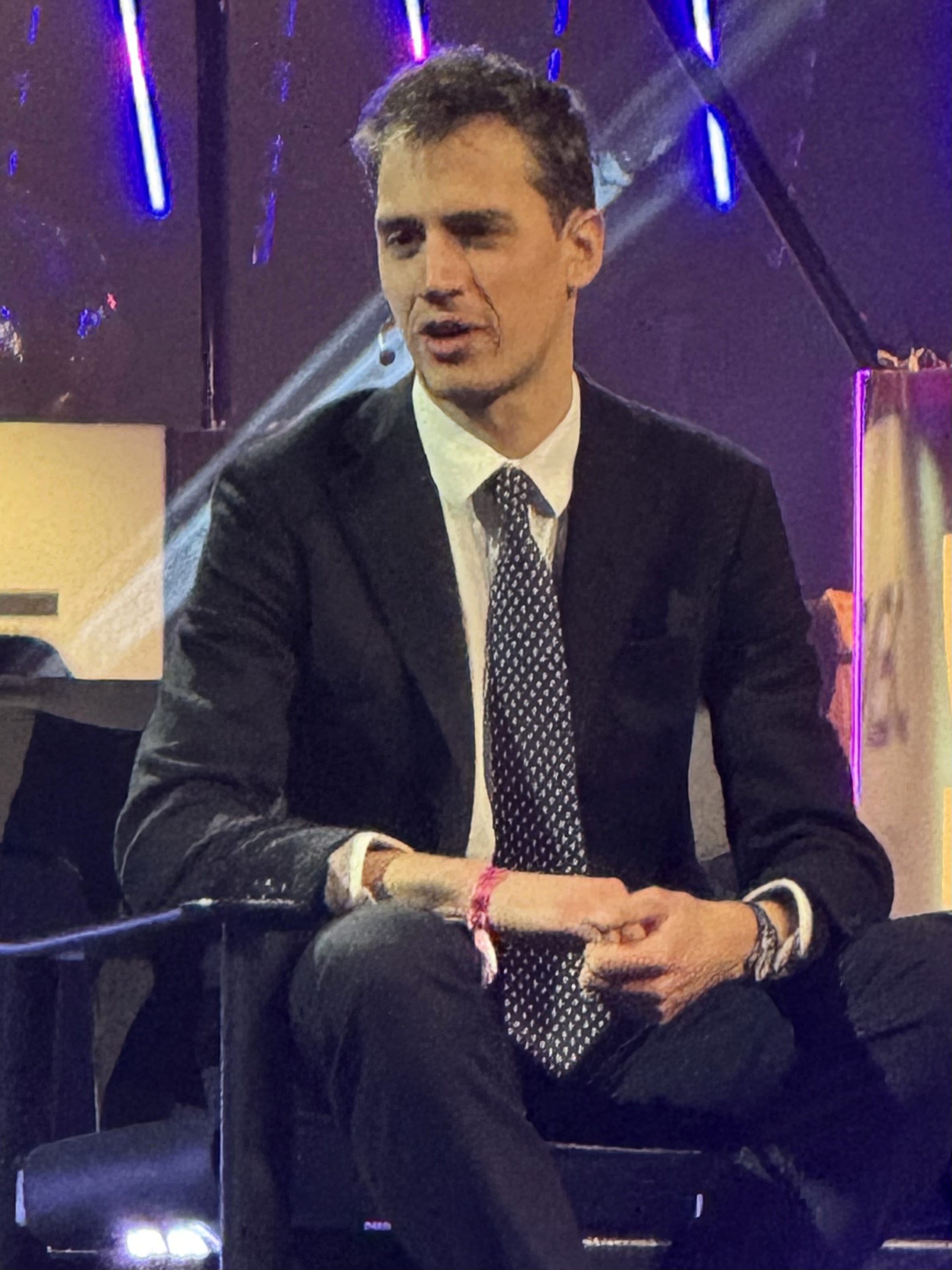 Arthur Mensch, chief executive of Mistral AI, speaking on stage in a dark suit and patterned tie.