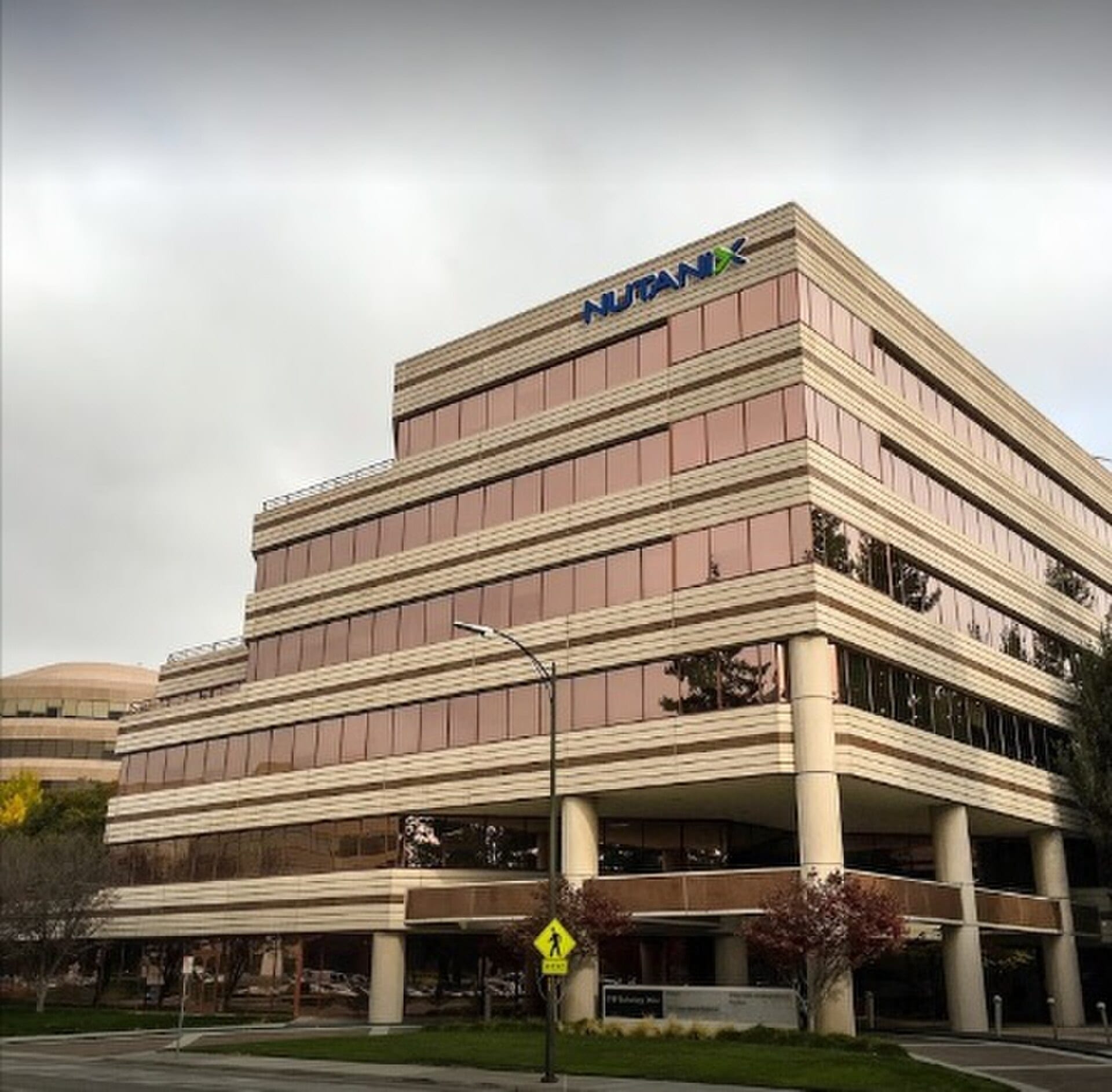 Nutanix headquarters building in San Jose, California, with the company logo on the top floor
