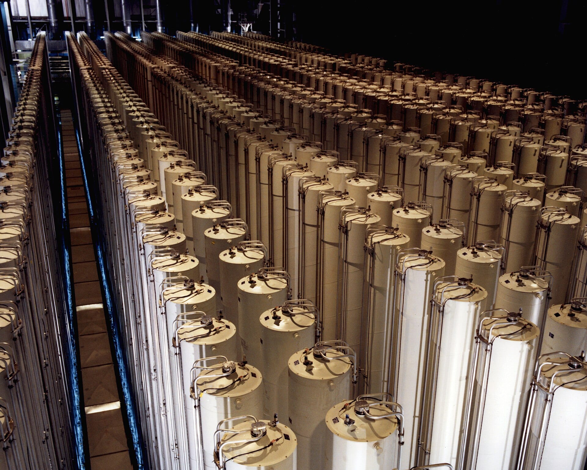 Rows of gas centrifuges in an enrichment plant cascade