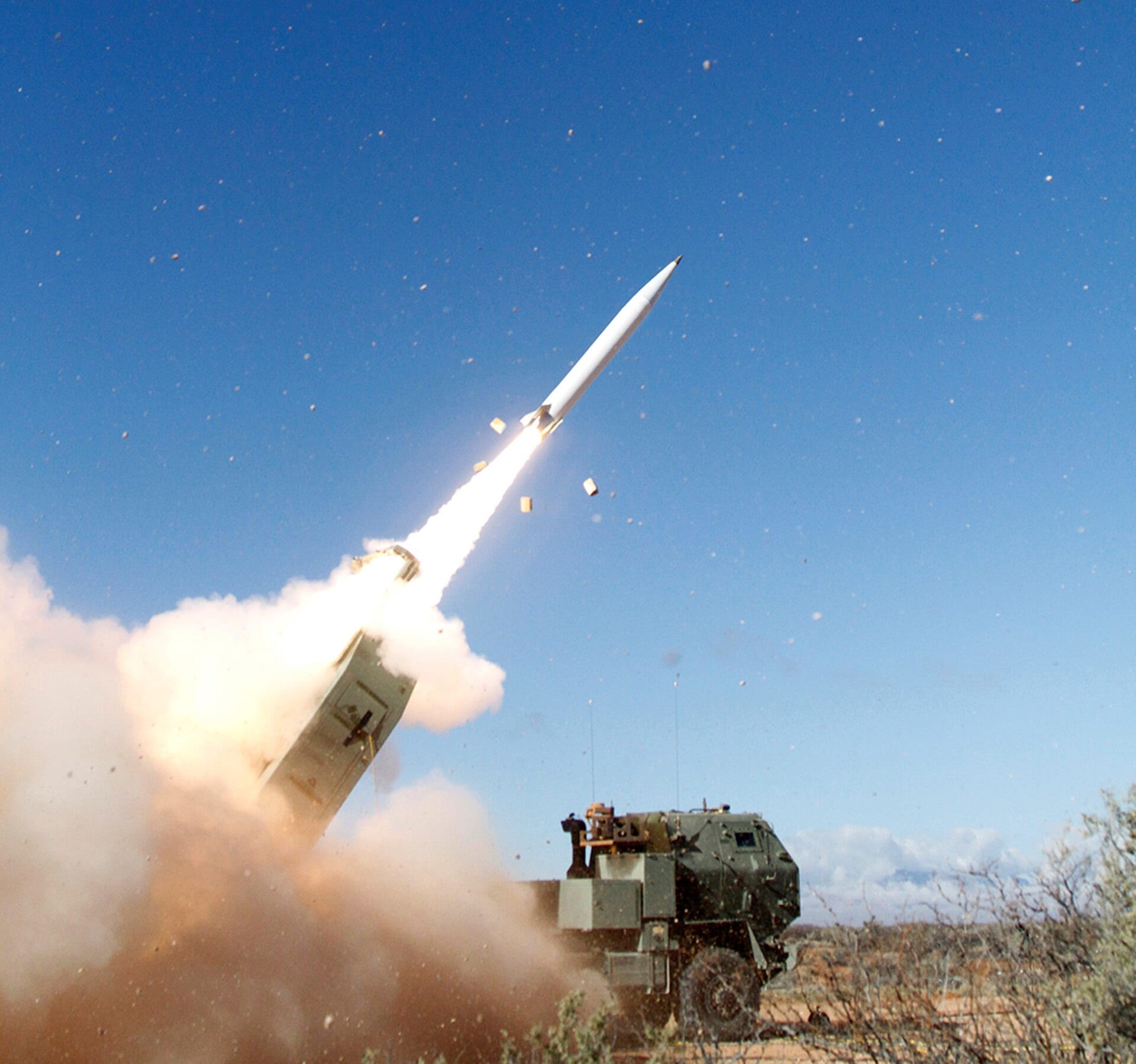 A Precision Strike Missile launches from a HIMARS vehicle during the Increment 1 limited user test, trailing flame and dust.