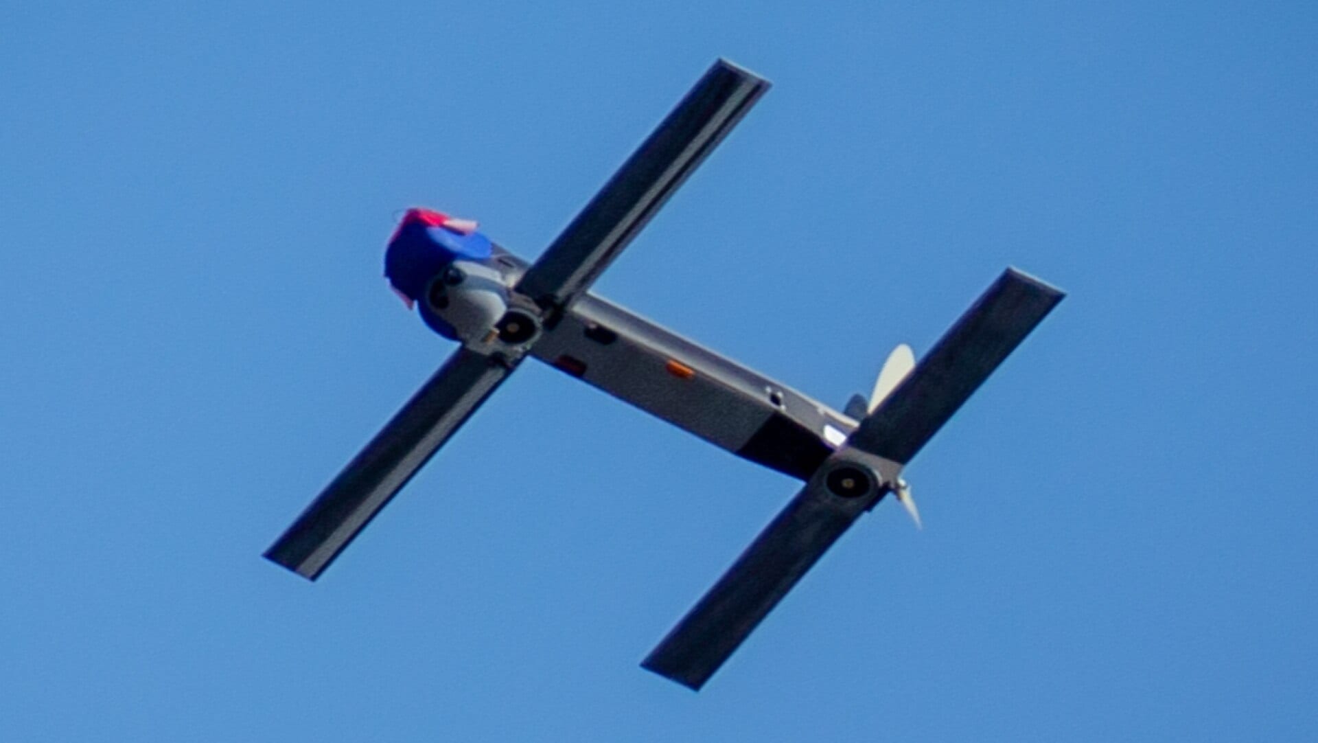 An AeroVironment Switchblade 300 loitering munition in flight against a clear blue sky