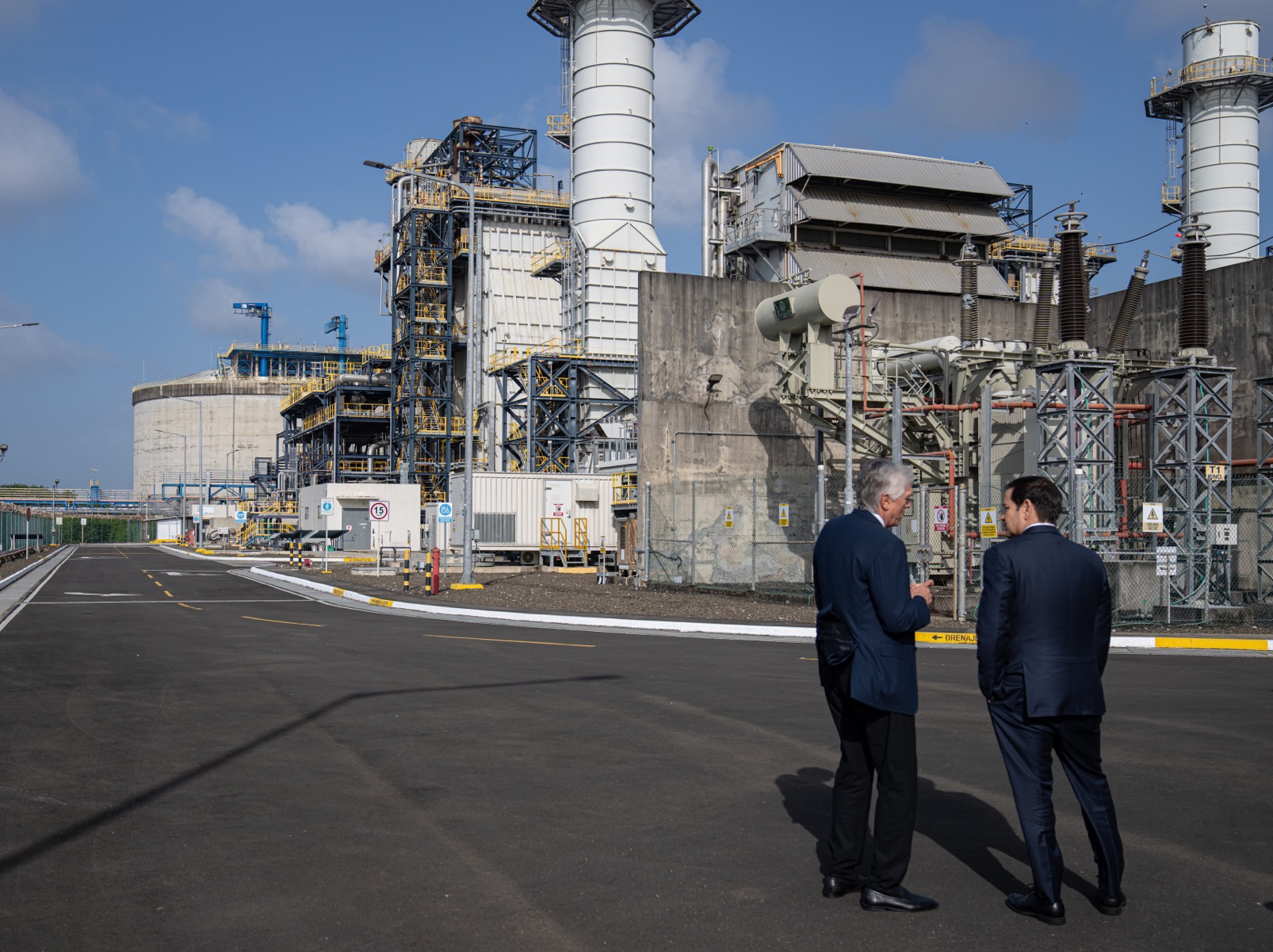 Secretary of State Marco Rubio shakes hands with AES chief executive Andres Gluski at an AES liquefied natural gas facility in Colon, Panama, in February 2025